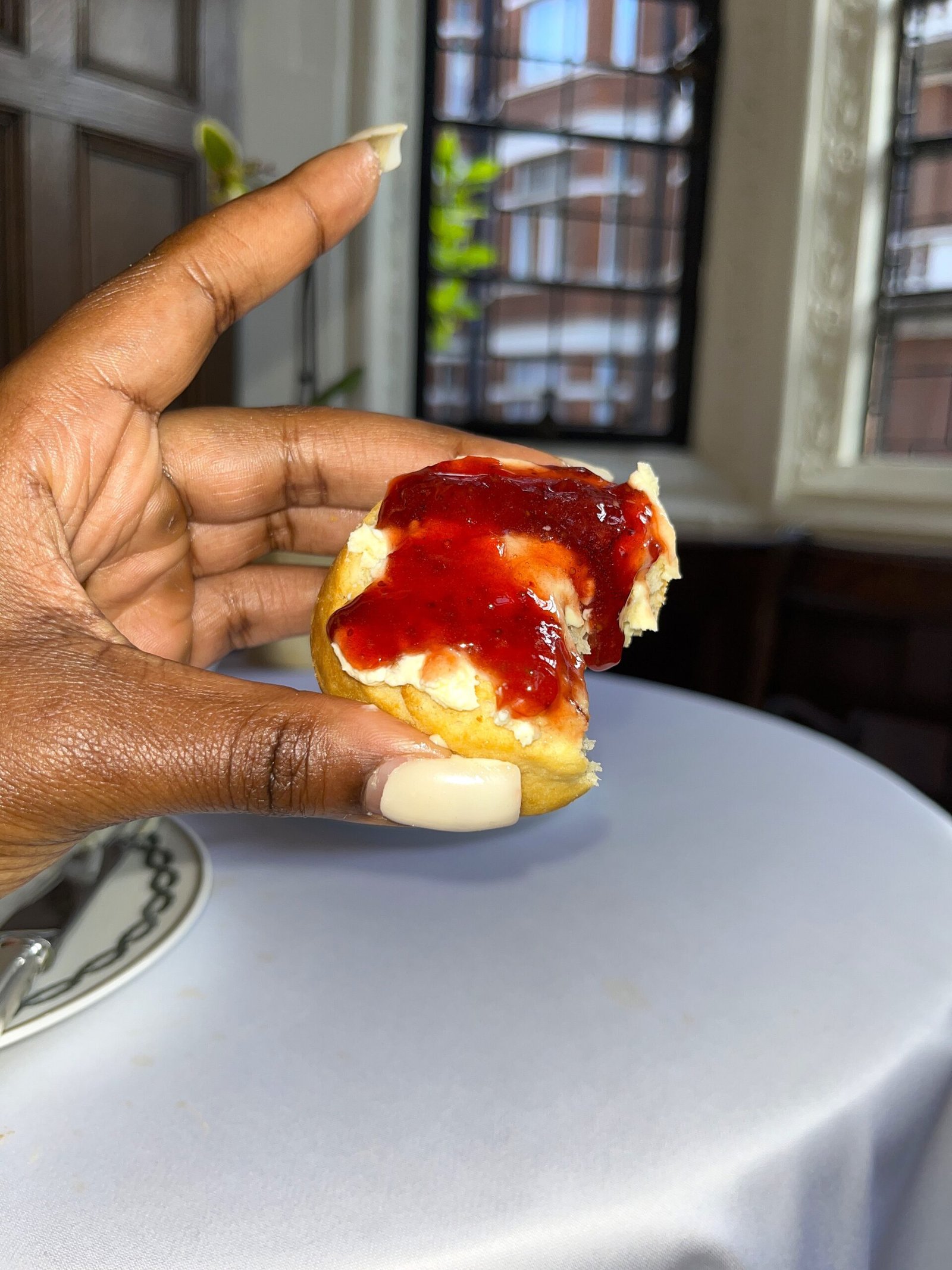 strawberry jam and clotted cream on a scone 